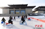 图为游人畅玩鸣沙山下的滑冰场。　杨艳敏 摄 - 甘肃新闻