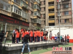 图为学校孩子们为老师和志愿者代表佩戴红领巾 郭蓉 摄 - 甘肃新闻