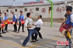 图为老师向学生示范凉州“攻鼓子”舞步和阵法。　钟欣 摄 - 甘肃新闻