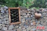 图为村民们不用的废旧陶罐成景观墙装饰。　李智谋 摄 - 甘肃新闻