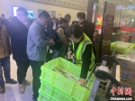 图为机场工作人员为旅客发放延误餐食。　杨曦 摄 - 甘肃新闻