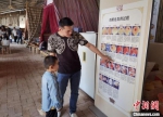 在甘肃榆中养鸡的台商孙永瑞，他正在自家的“好鲜生农场”给前来参观的小朋友讲解小鸡孵化的过程。(资料图) 丁思 摄 - 甘肃新闻