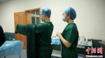 图为学生在练习穿脱手术衣。(资料图) 甘肃中医药大学第一临床医学院供图 - 甘肃新闻